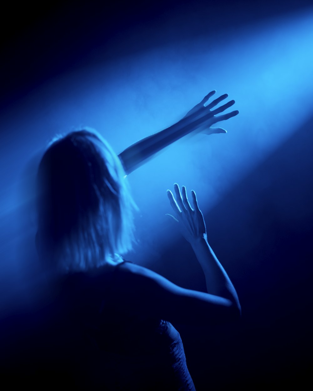 woman in black tank top raising her hands