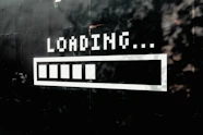 A white loading bar with five filled segments on a black wall