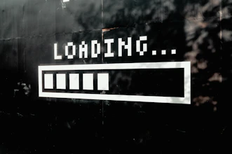 A white loading bar with five filled segments on a black wall