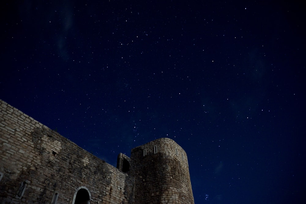 brown brick building under starry night