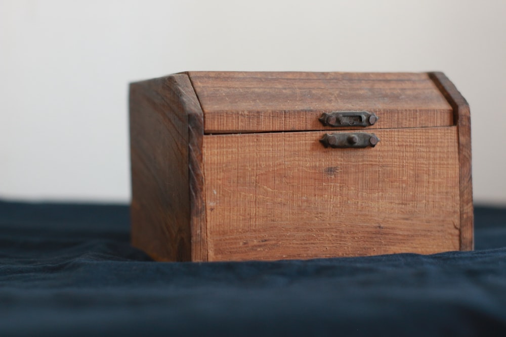 brown wooden chest box on black table