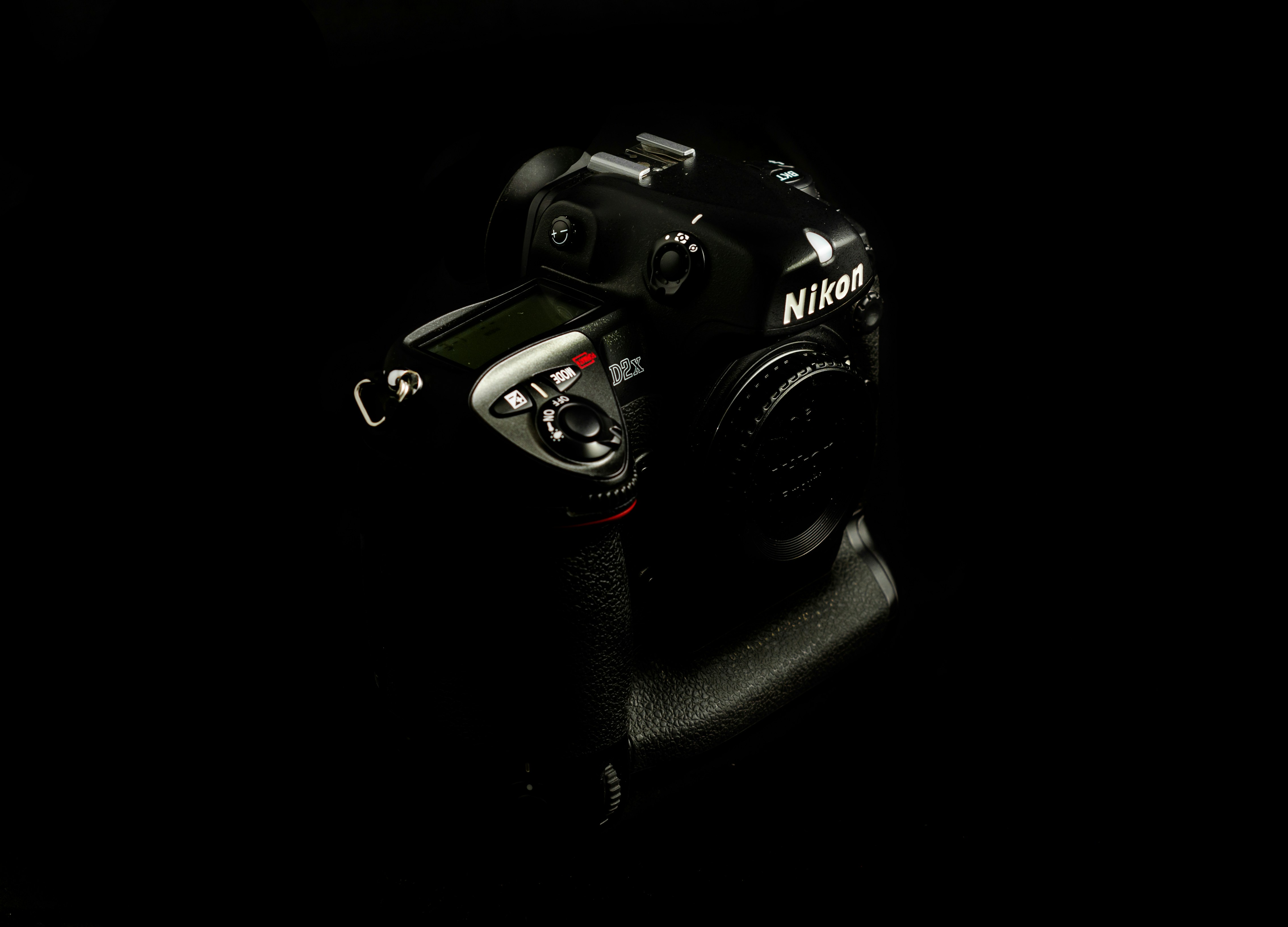 Appareil photo reflex numérique Nikon noir sur surface noire