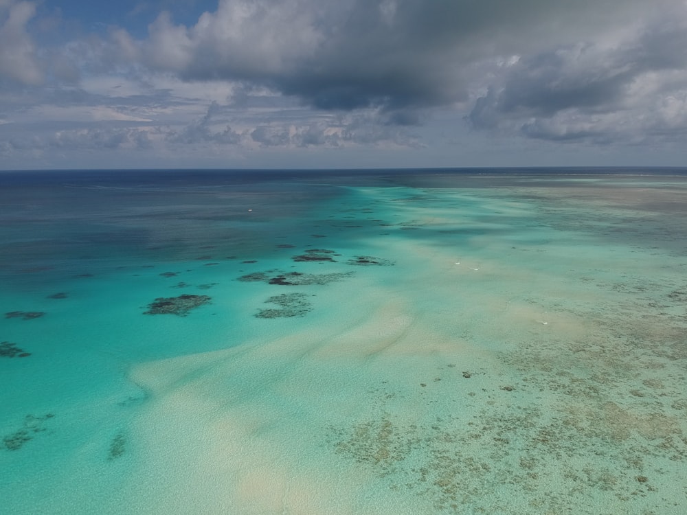 blue sea under white clouds during daytime