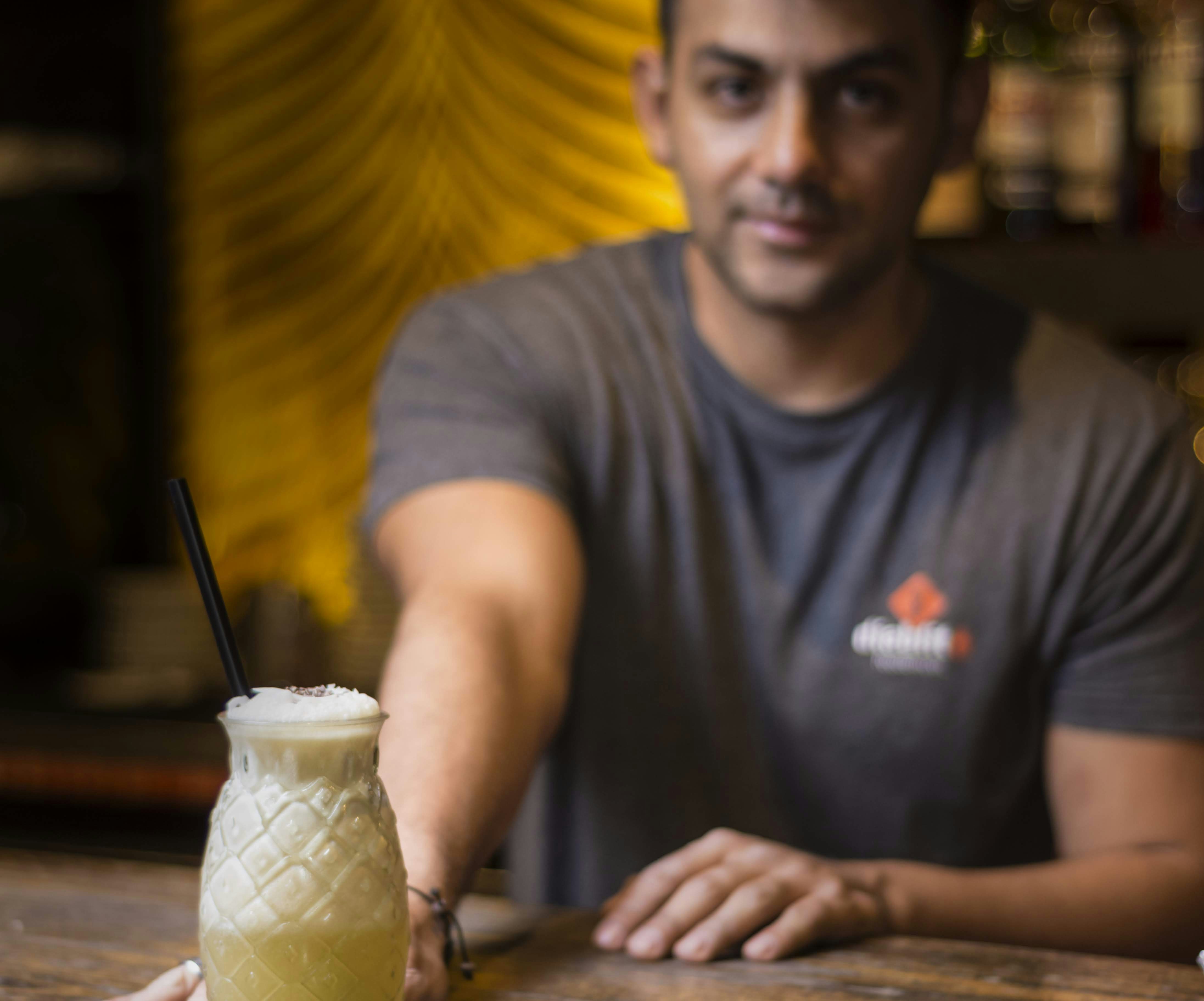 man in gray crew neck t-shirt sitting beside brown wooden table, cocktails season 2019