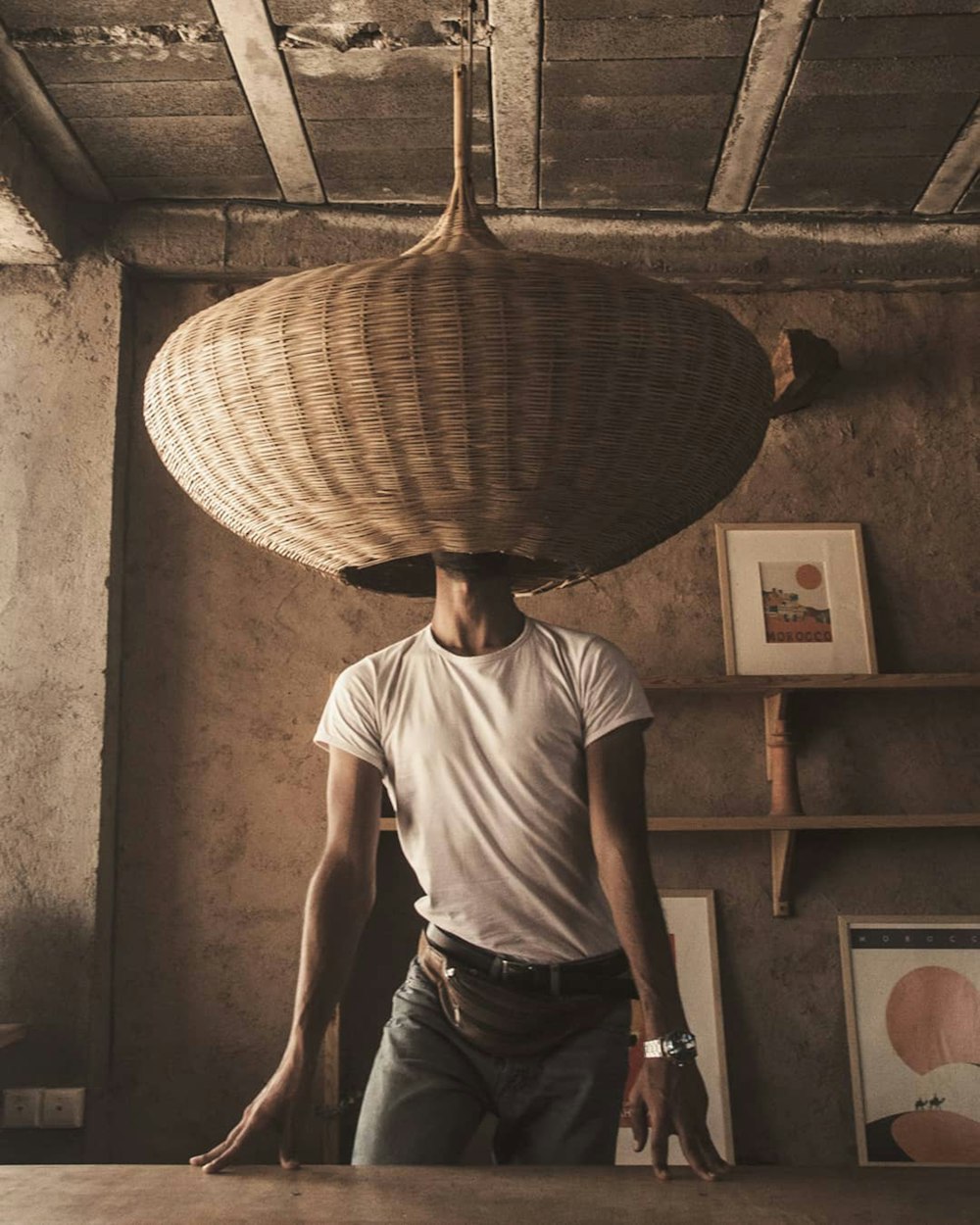 man in white crew neck t-shirt and black pants wearing brown straw hat