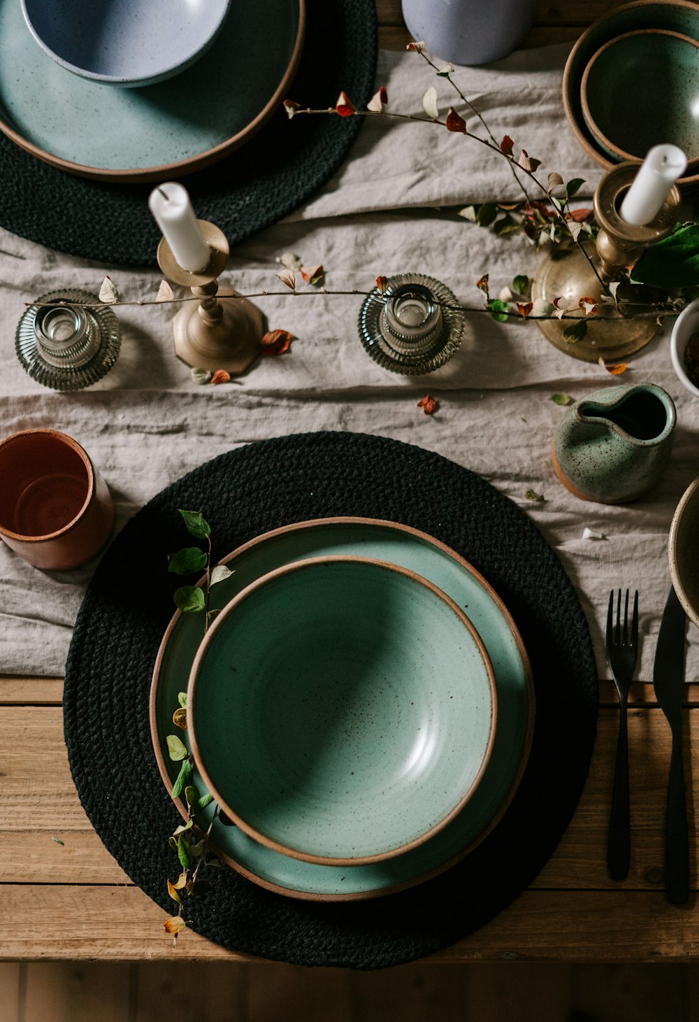 green ceramic plate on black table mat