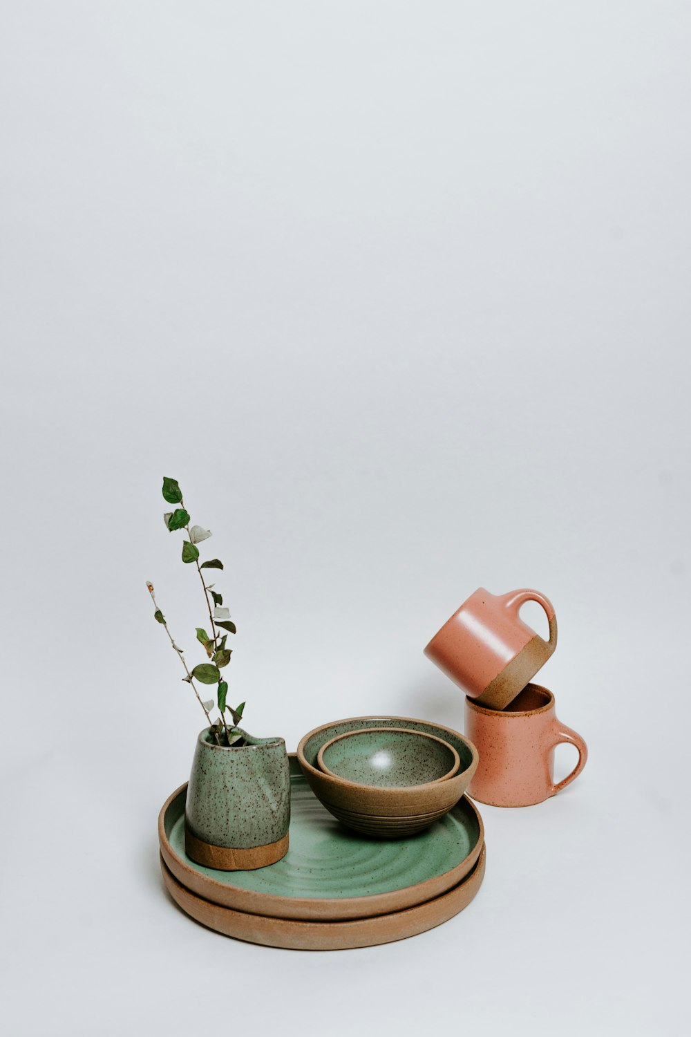 green and pink ceramic mugs