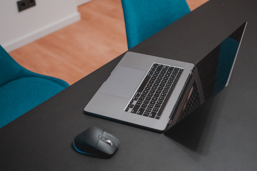 black cordless computer mouse on gray laptop computer