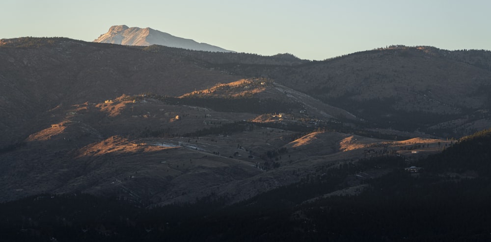 brown and green mountains under white sky during daytime