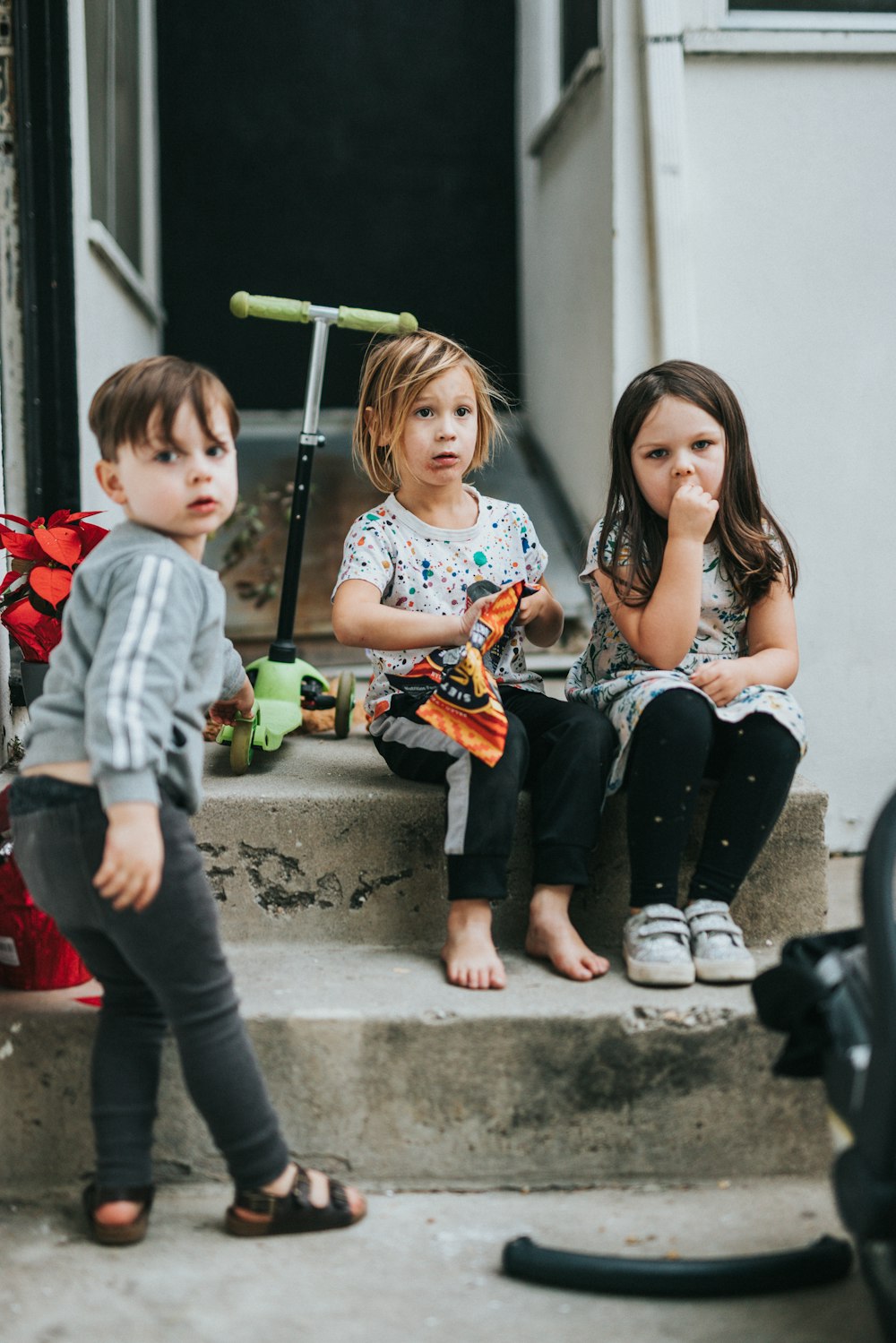 woman in black tank top sitting beside boy in red and black jacket