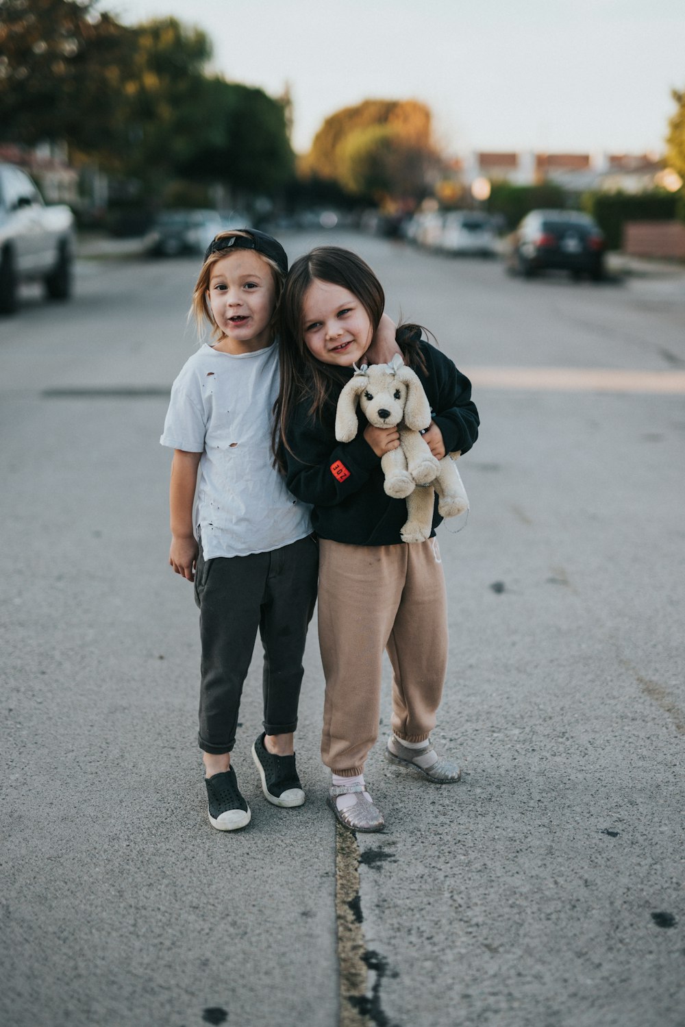 woman in white shirt hugging girl in white shirt