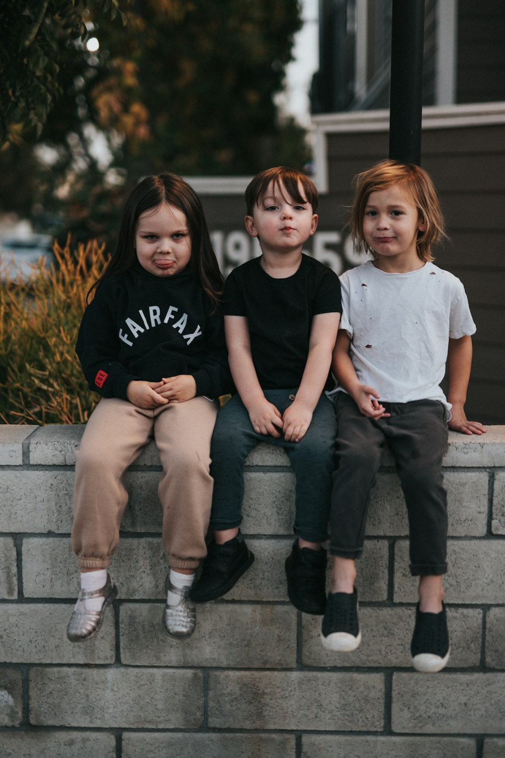 3 boys sitting on concrete stairs