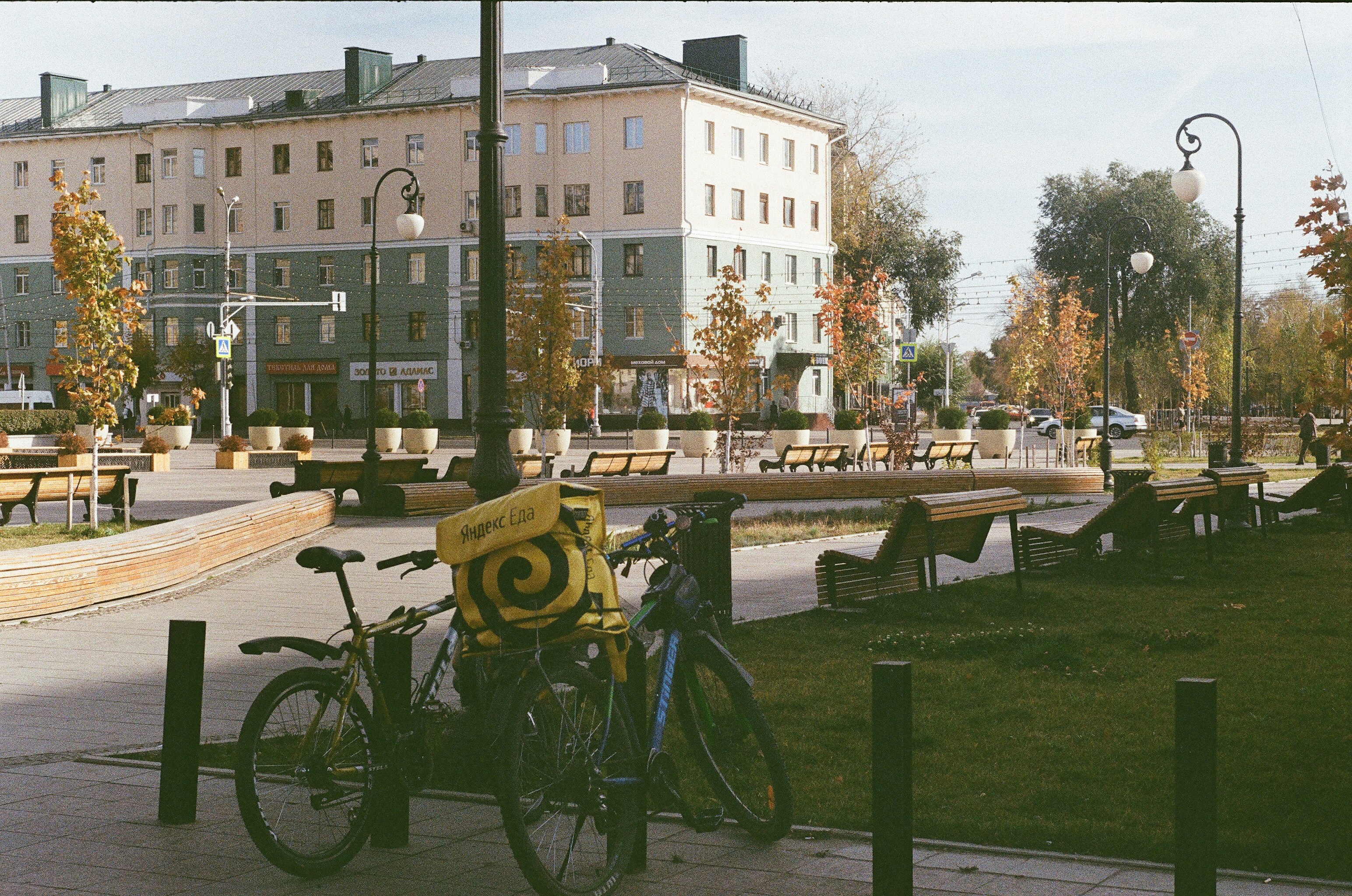 black bicycle parked on green grass field near brown concrete building during daytime