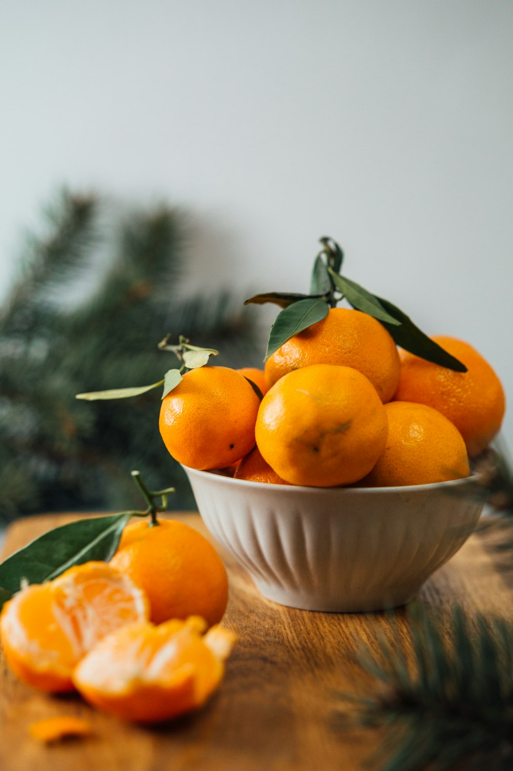 orange fruits in white ceramic bowl