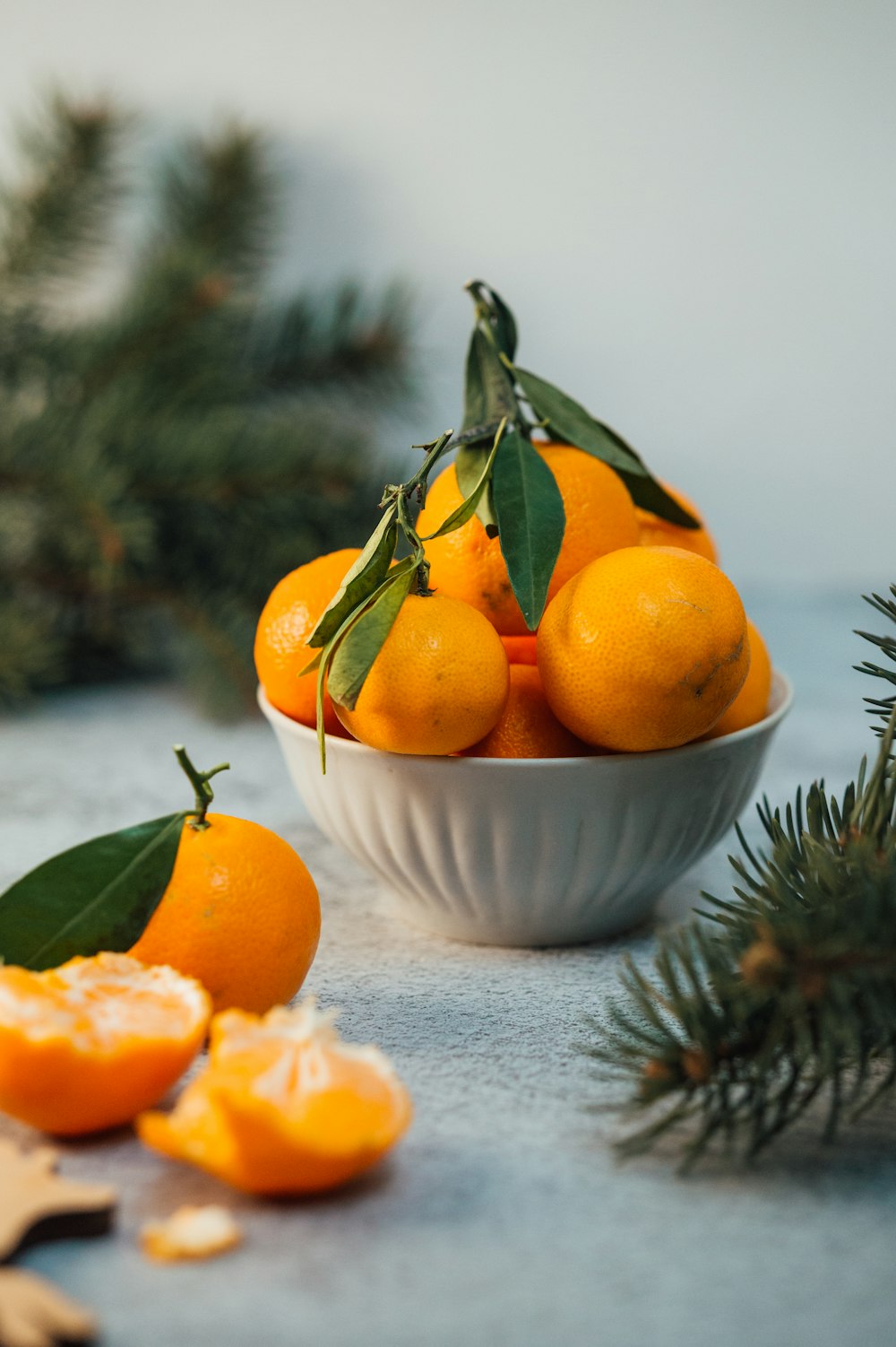 orange fruits in white ceramic bowl