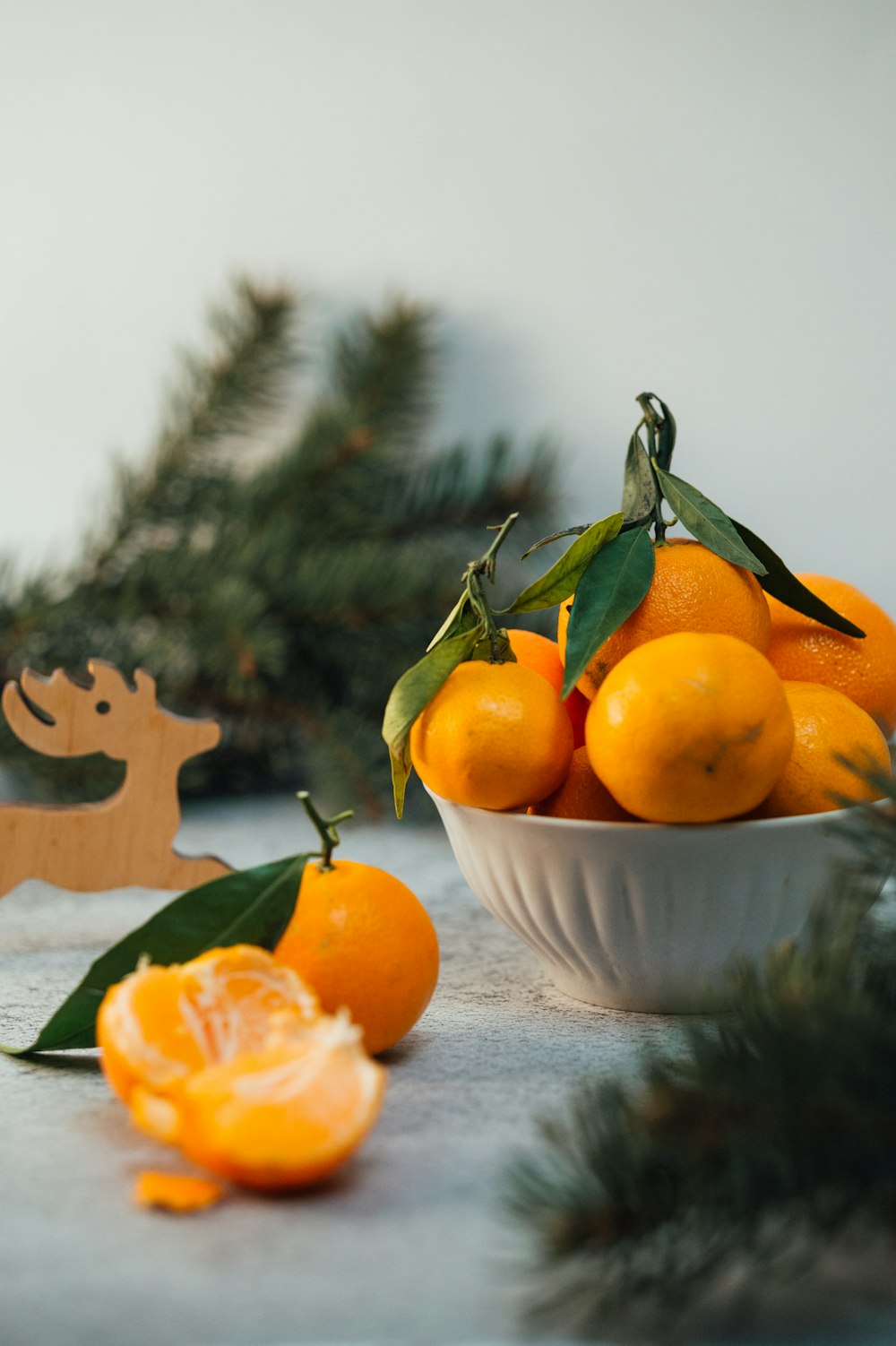 orange fruits on white ceramic bowl