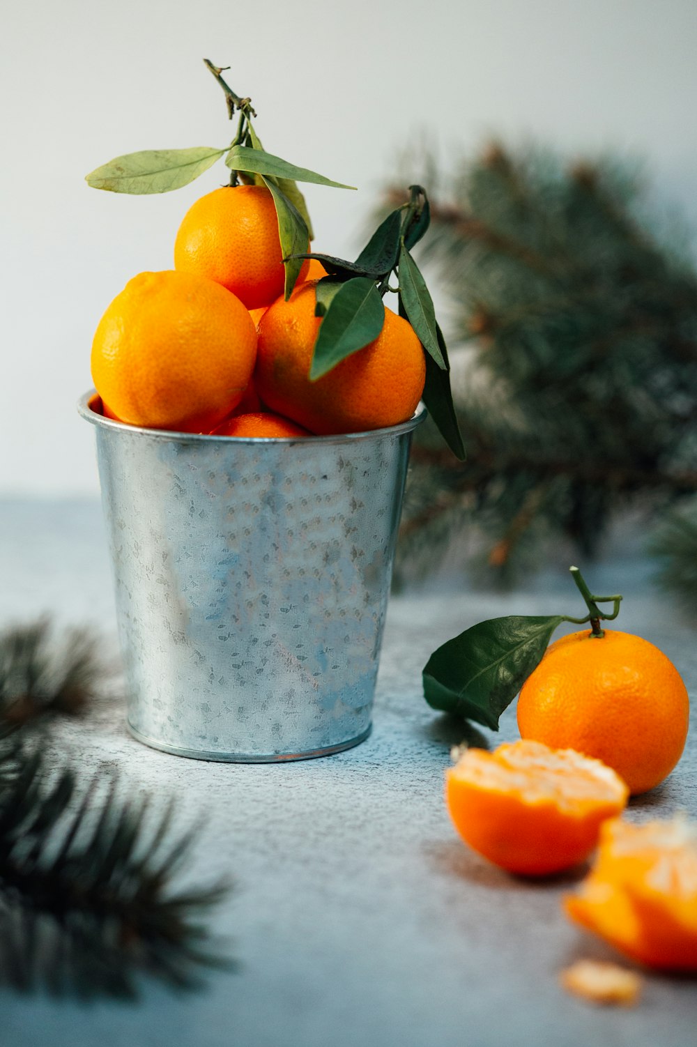 orange fruits in gray bucket