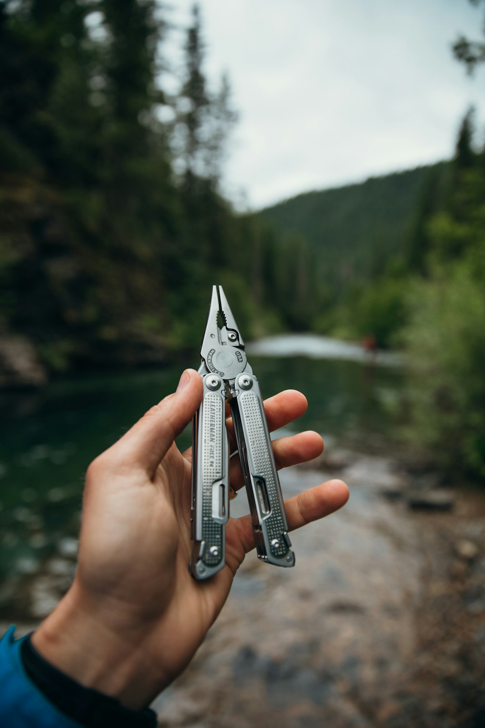 a person holding a pair of scissors in their hand