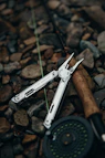 a pair of scissors sitting on top of a pile of rocks
