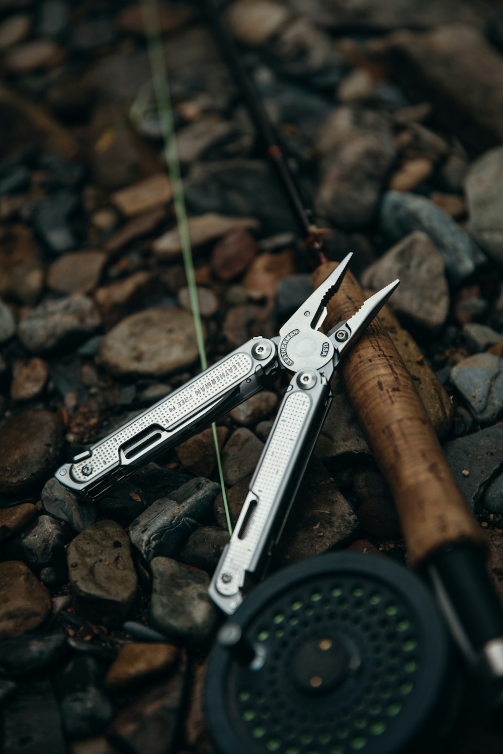 a pair of scissors sitting on top of a pile of rocks