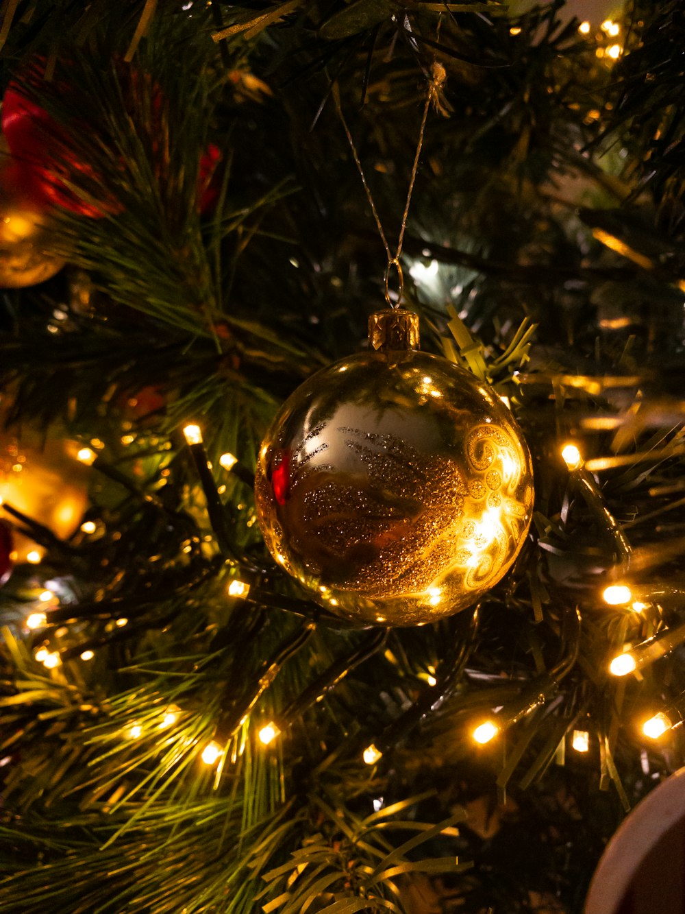 gold christmas baubles on christmas tree