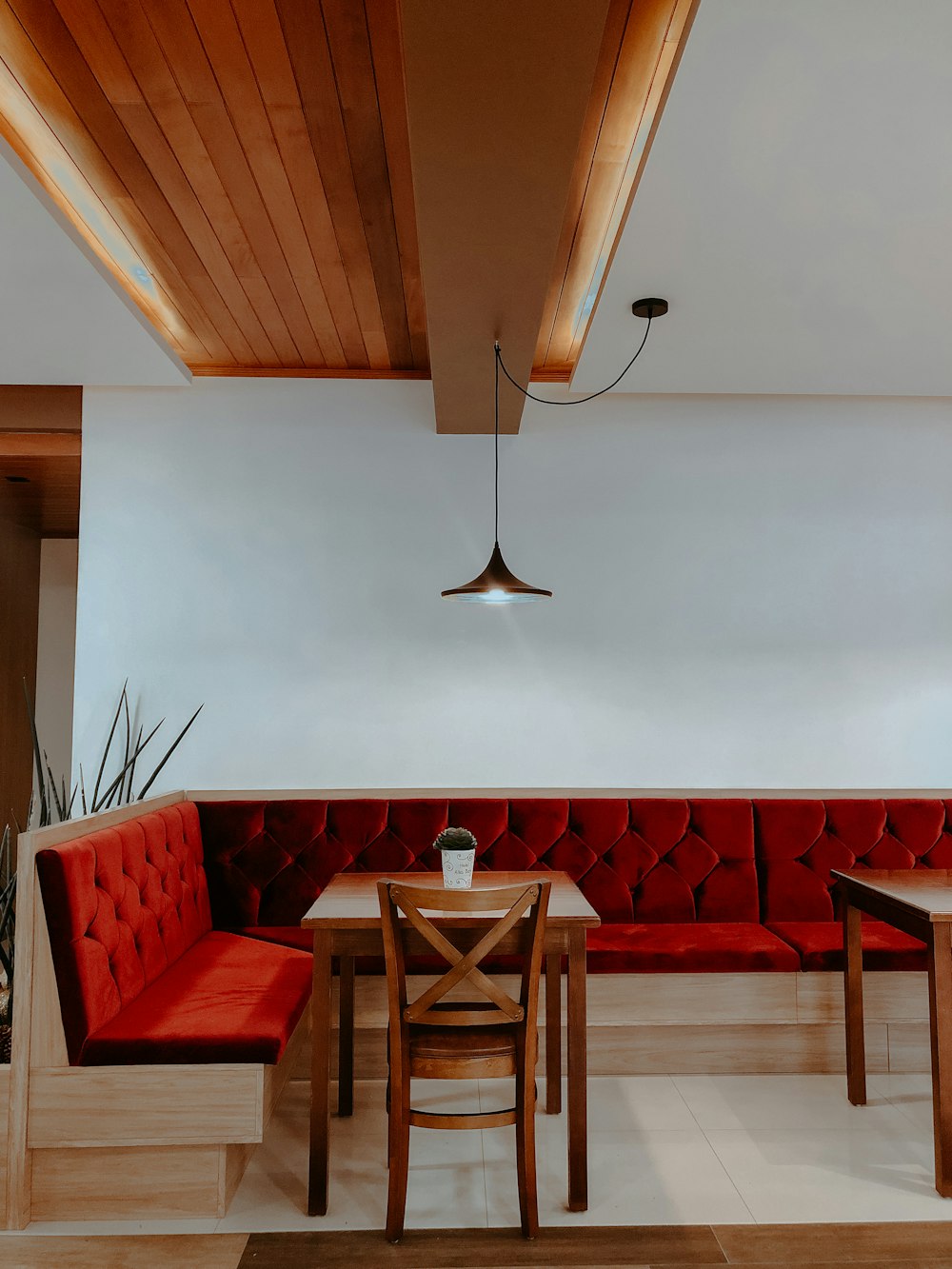 red and brown wooden chairs and table