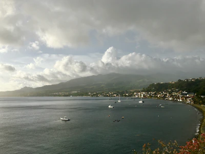 A scenic shot of Huatulco’s bays with boats gently floating on calm waters at dawn.
