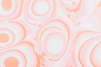 Swirling patterns of smooth, pastel-colored circles and waves create a marbled effect. The design consists primarily of soft oranges and pinks against a lighter background, giving a sense of fluidity and calm.