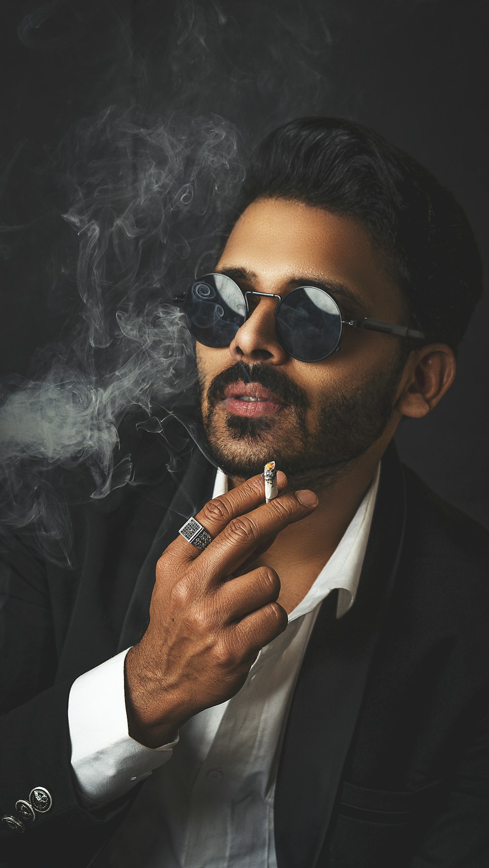 man in black sunglasses smoking cigarette