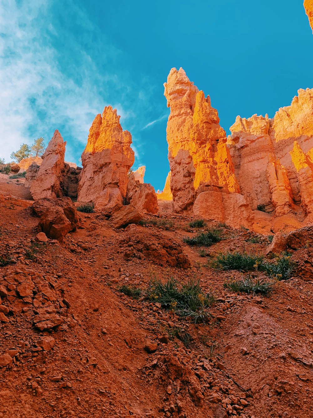 a group of rocks sitting on top of a dirt hill