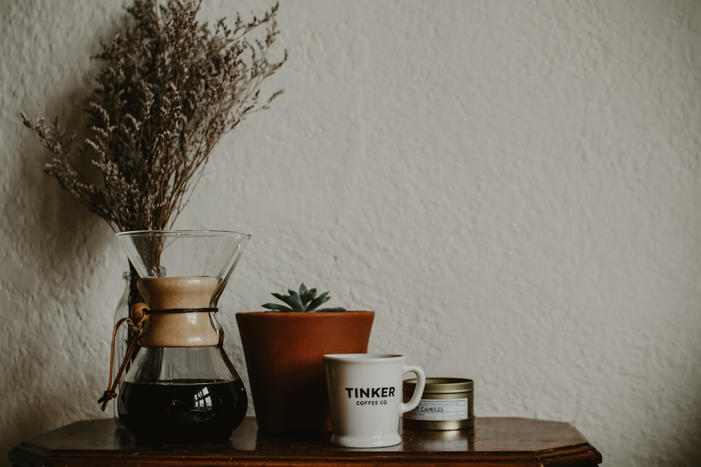 a wooden table topped with a cup of coffee