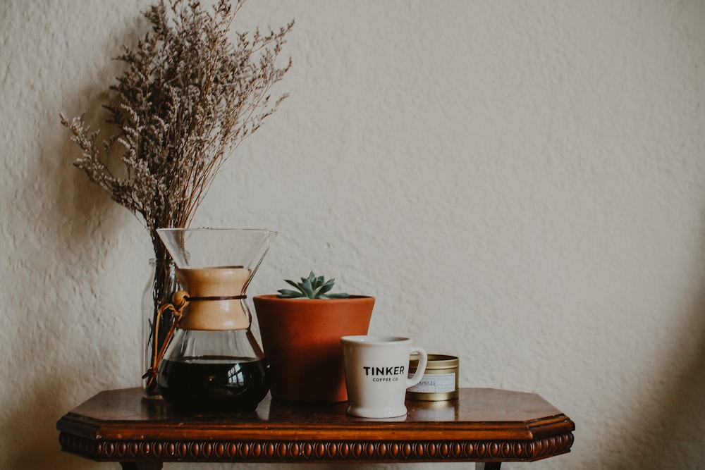 white ceramic cup on brown wooden table