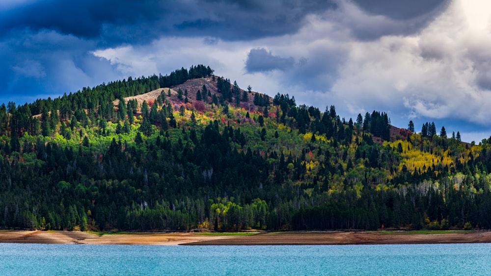 a large body of water with a mountain in the background