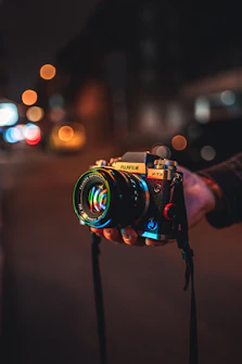 person holding black and silver nikon dslr camera