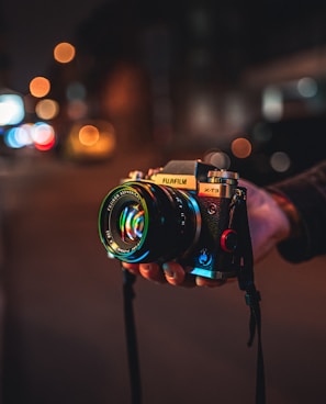 person holding black and silver nikon dslr camera