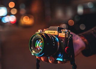 person holding black and silver nikon dslr camera