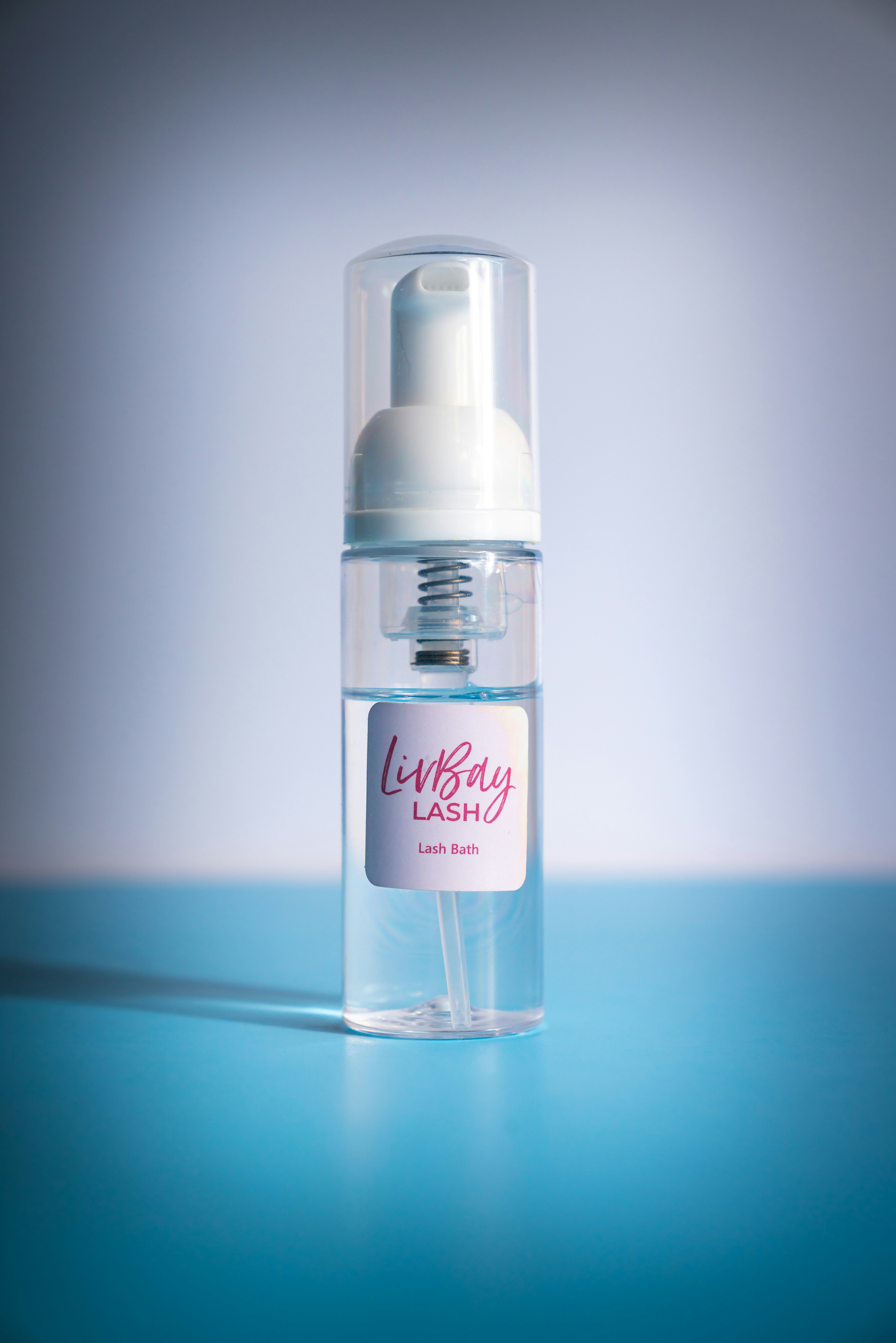 a bottle of lotion on a blue table