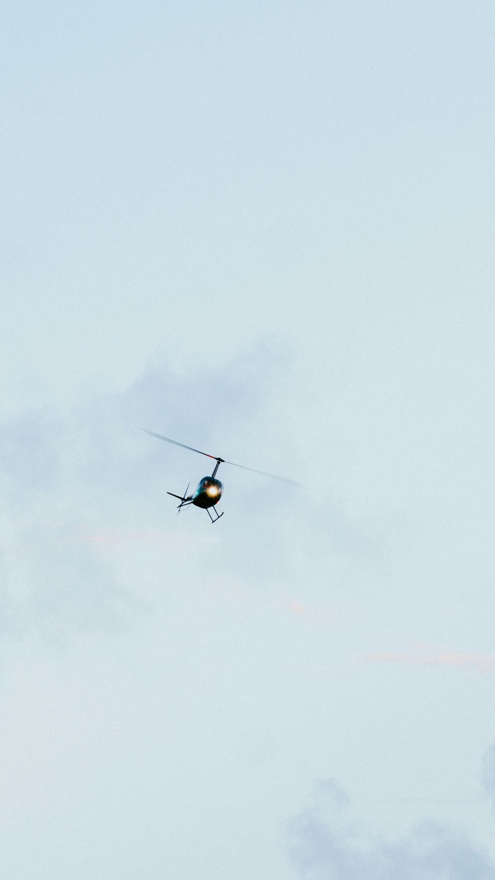 black and orange helicopter flying in the sky