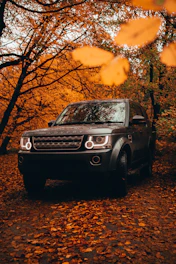 black mercedes benz g class suv parked near trees during sunset