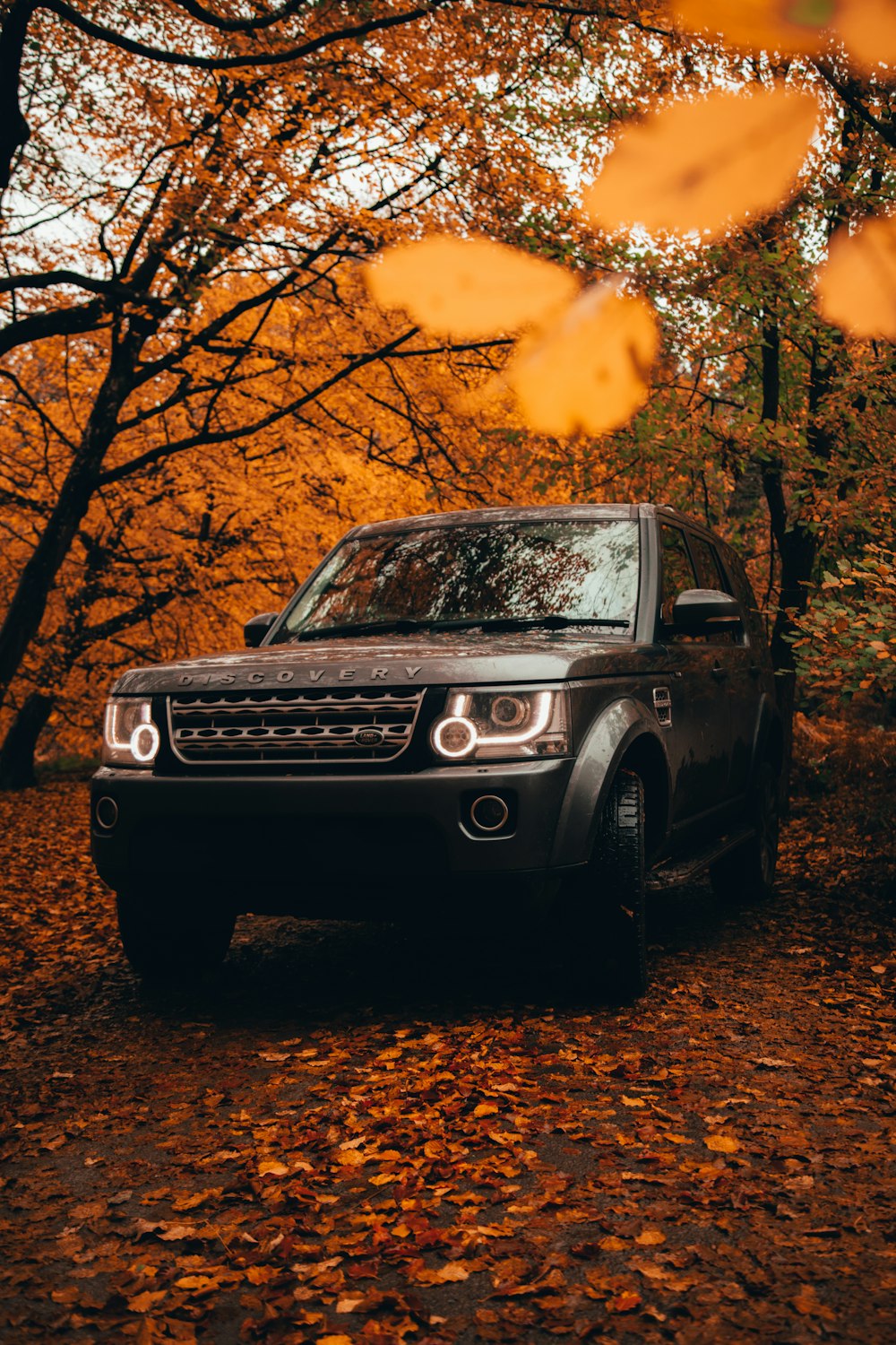 black mercedes benz g class suv parked near trees during sunset