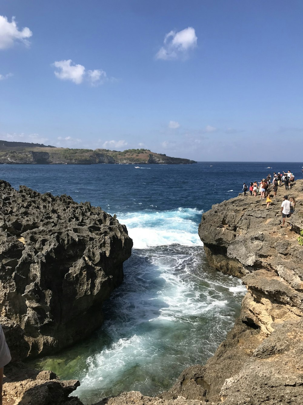 people on rocky shore during daytime