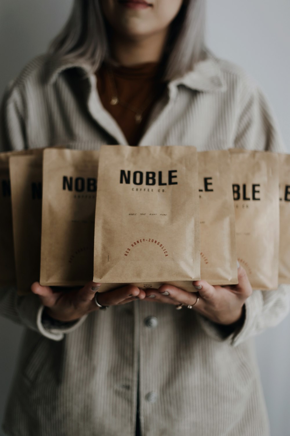 person holding brown paper bag