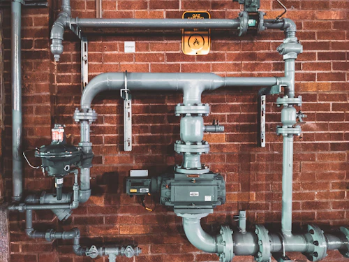Copper and steel pipework on a brick wall