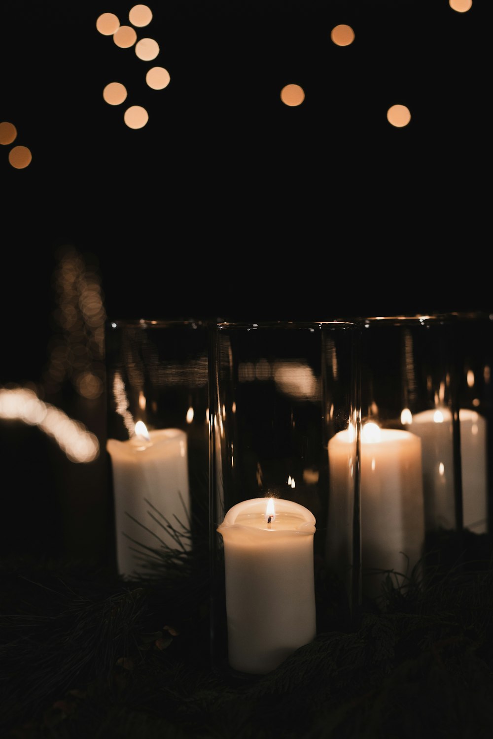 white pillar candles on black metal candle holder