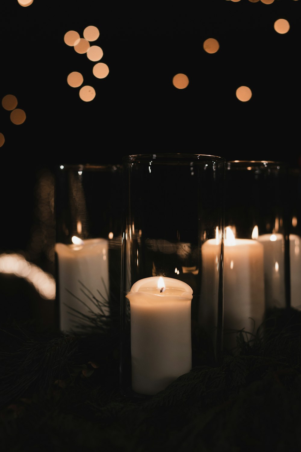 white pillar candles on black metal candle holder