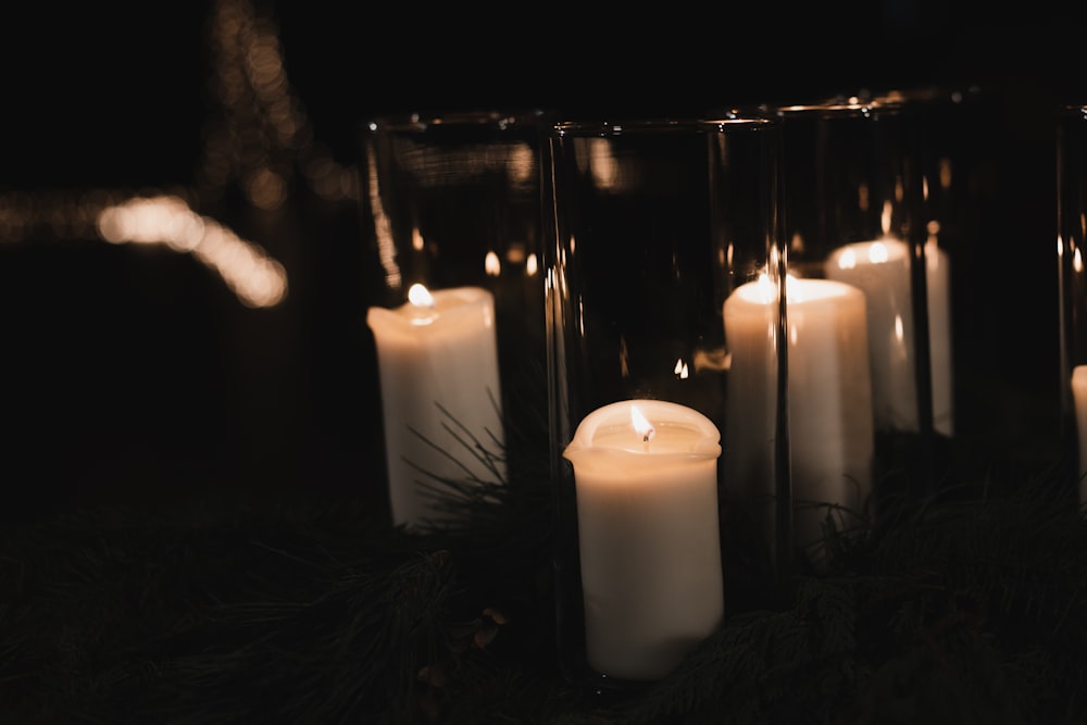 white pillar candles on black metal candle holder