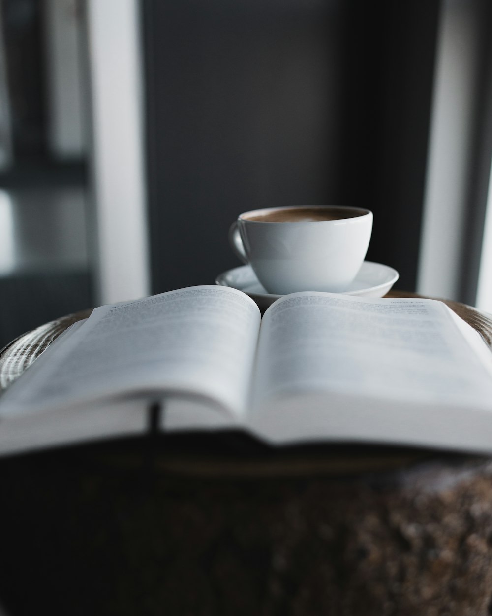 white ceramic teacup on white book page