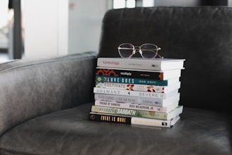 stack of books on black sofa