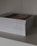 A stack of neatly arranged religious books with white covers displayed on a shelf, each titled with a different book of the Bible.