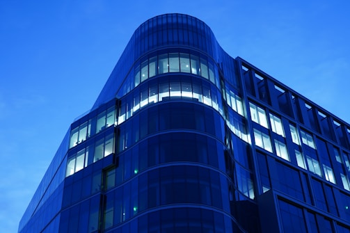 Abstract modern architecture with clean lines and blue-magenta lighting reflecting technological innovation.